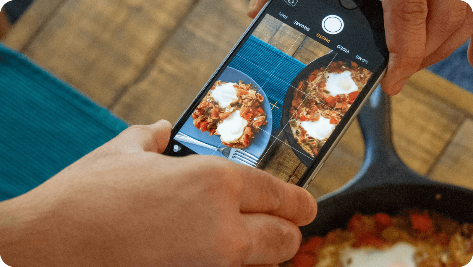 Image of restaurateur taking food photo