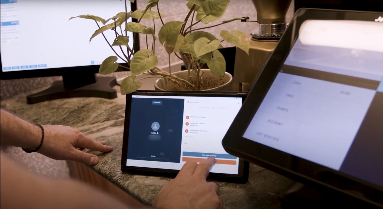 Image of restaurant staff using the Otter tablet to monitor orders