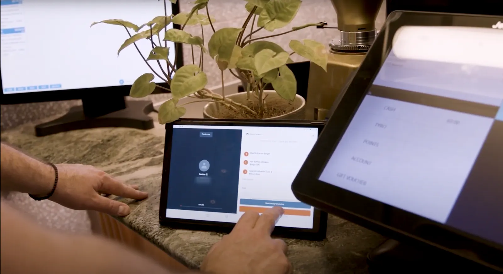 Image of restaurant staff using the Otter tablet to monitor orders