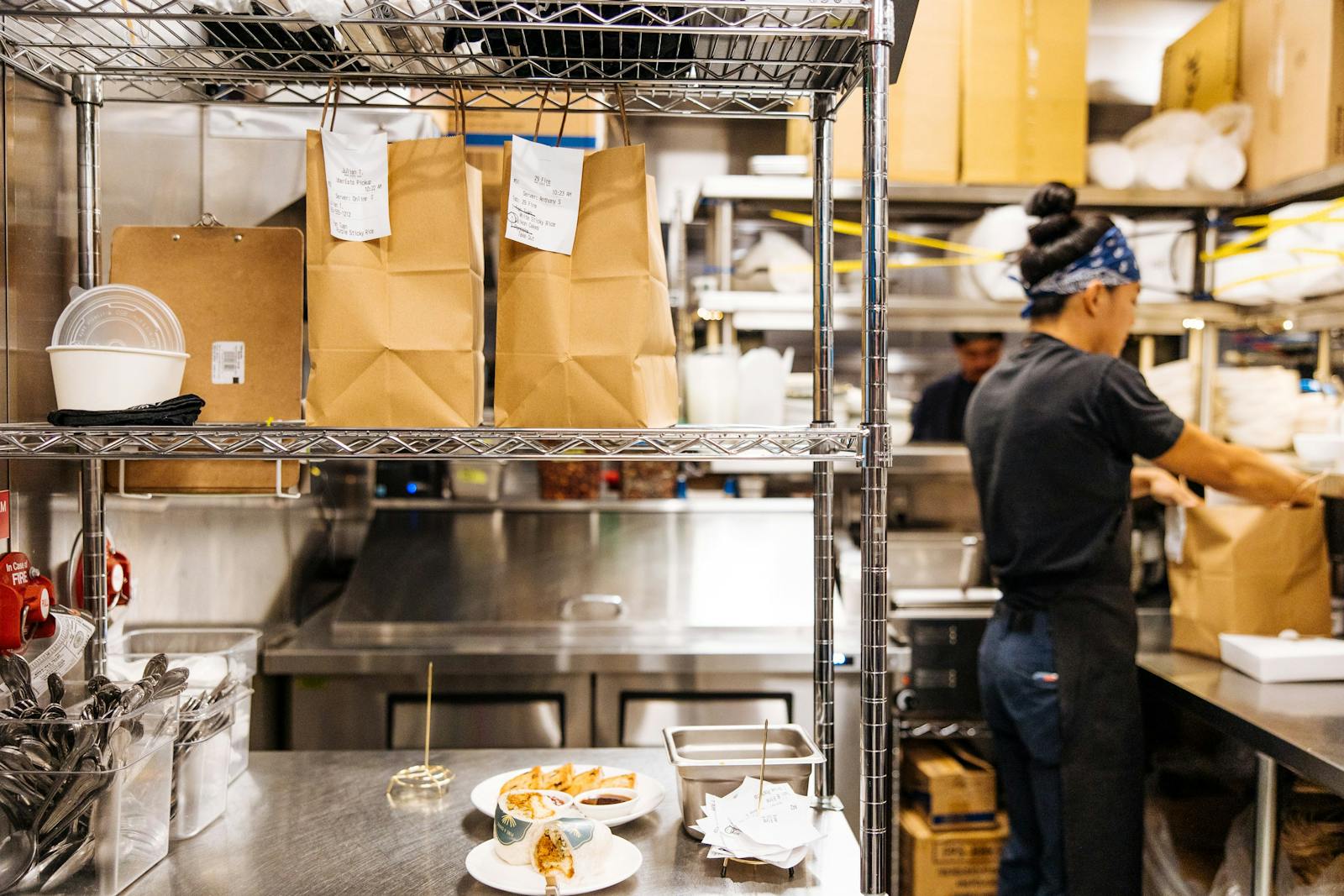 Image of a restaurant employee fulfilling delivery orders in the back-of-house.