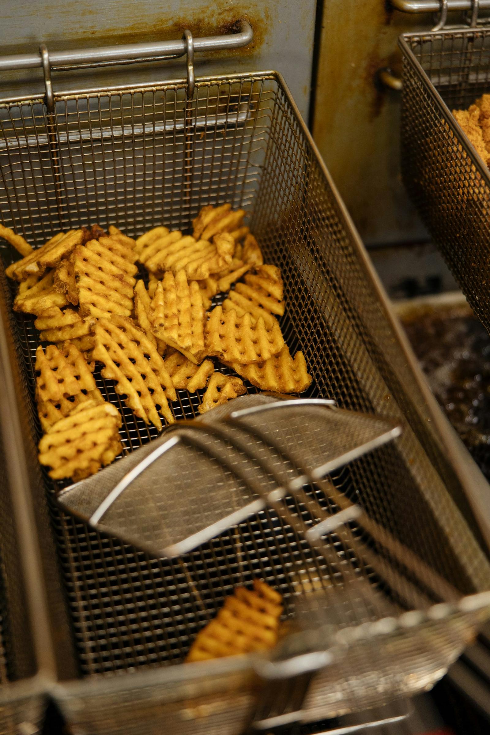 Image of waffle fries getting crispy after frying in oil