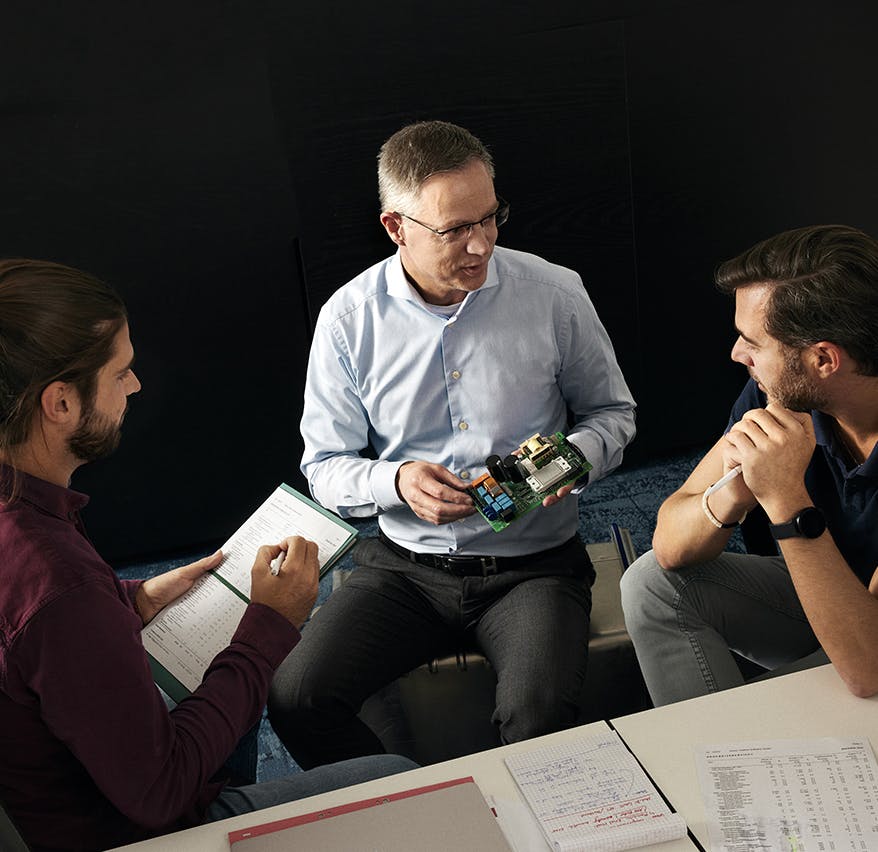 man explaining demo product to others