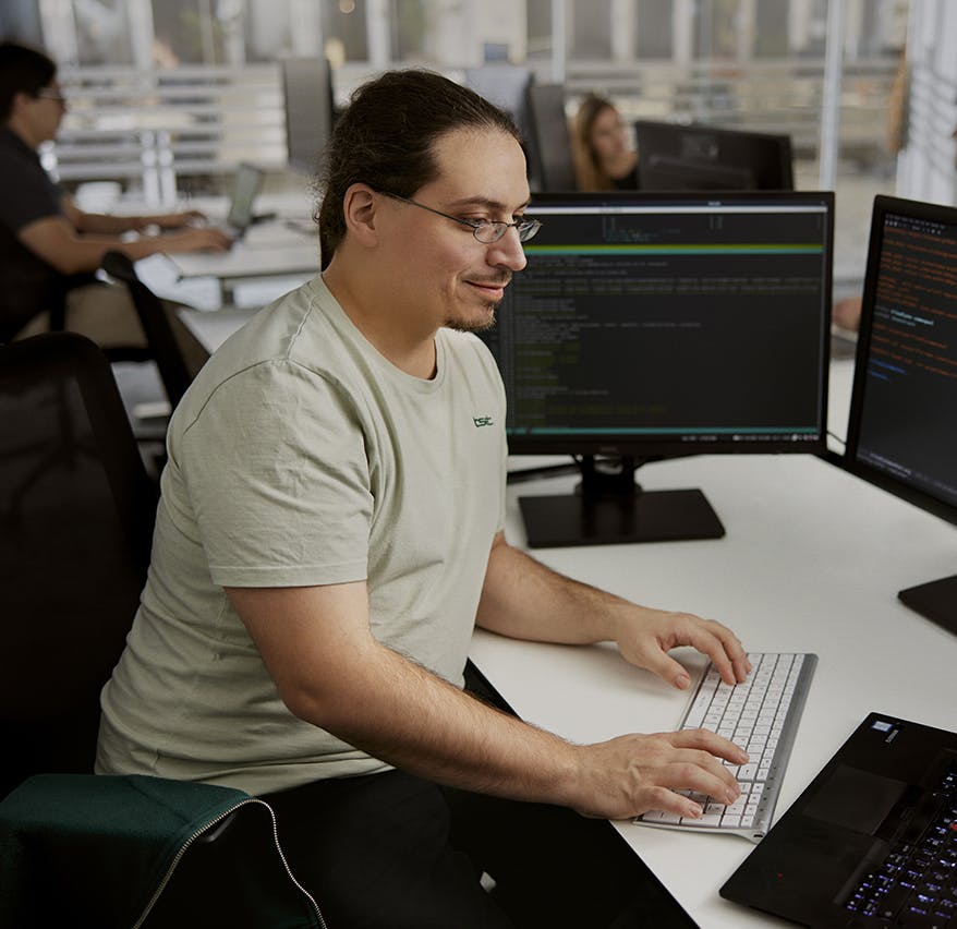 man in front the laptop writing on keyboard