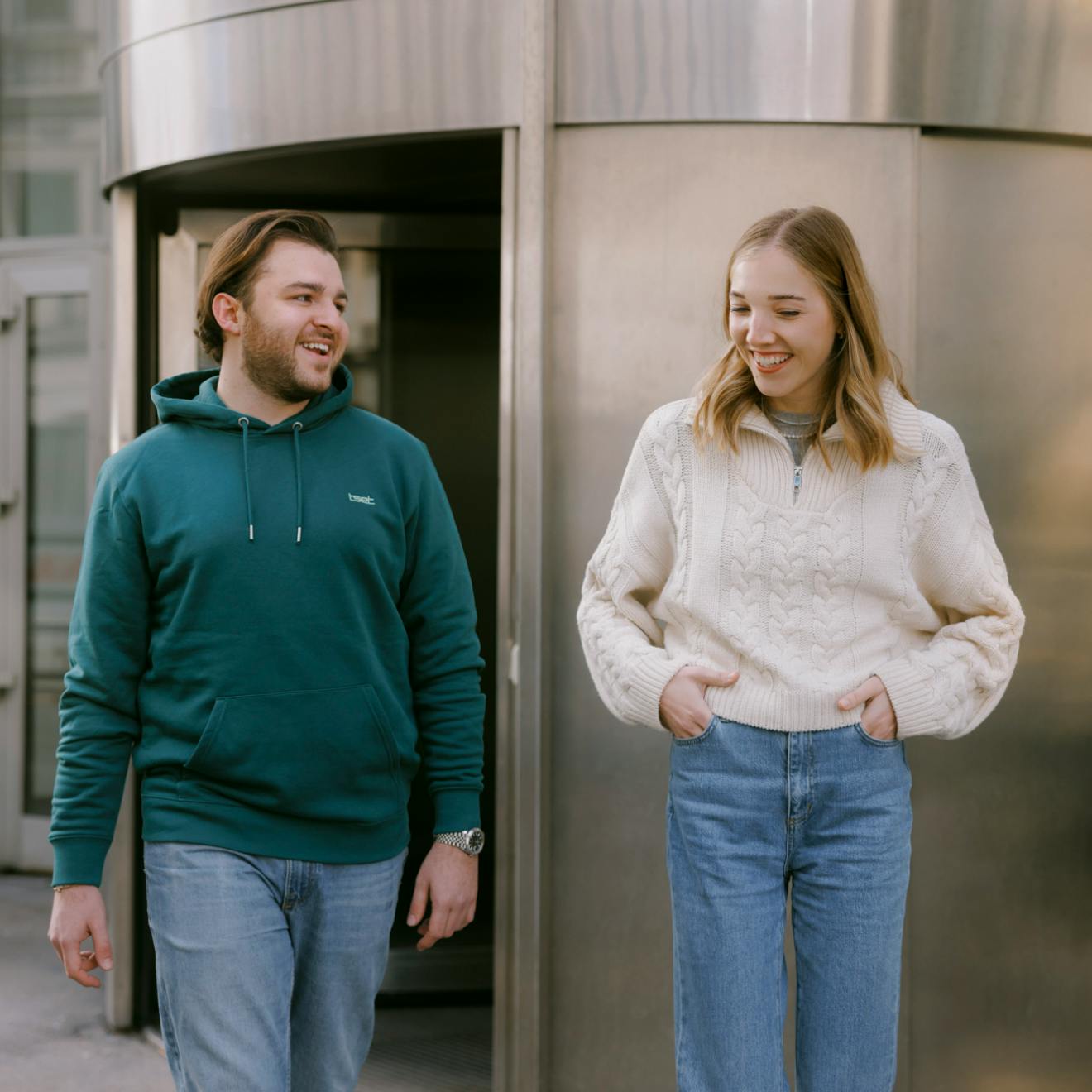 in front of the office two people laughing