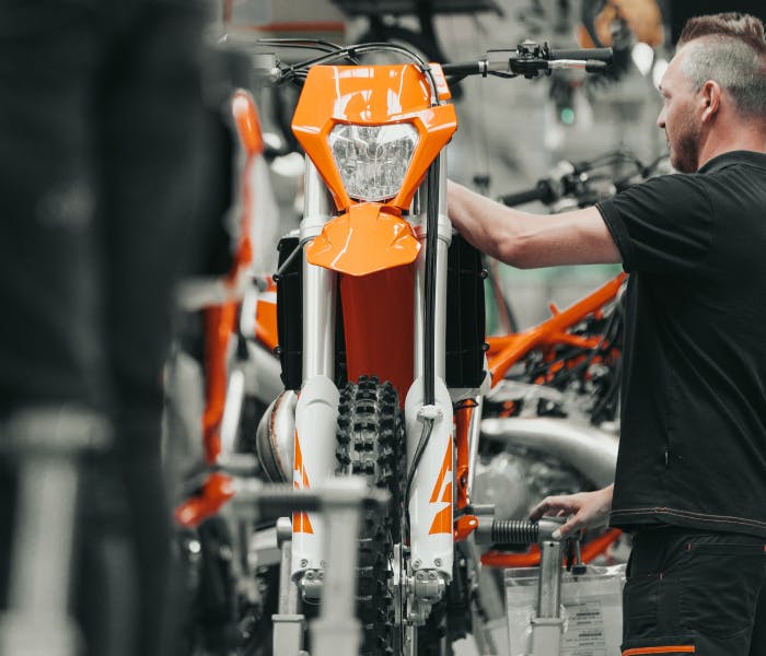 A man assembling a motorcycle in the factory