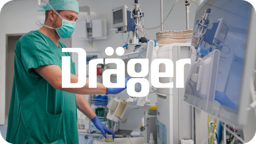 Healthcare professional in green scrubs and a surgical mask operating advanced medical equipment in a clinical setting, with the Dräger logo prominently overlaid in white—representing the company’s role in medical technology and patient care solutions.