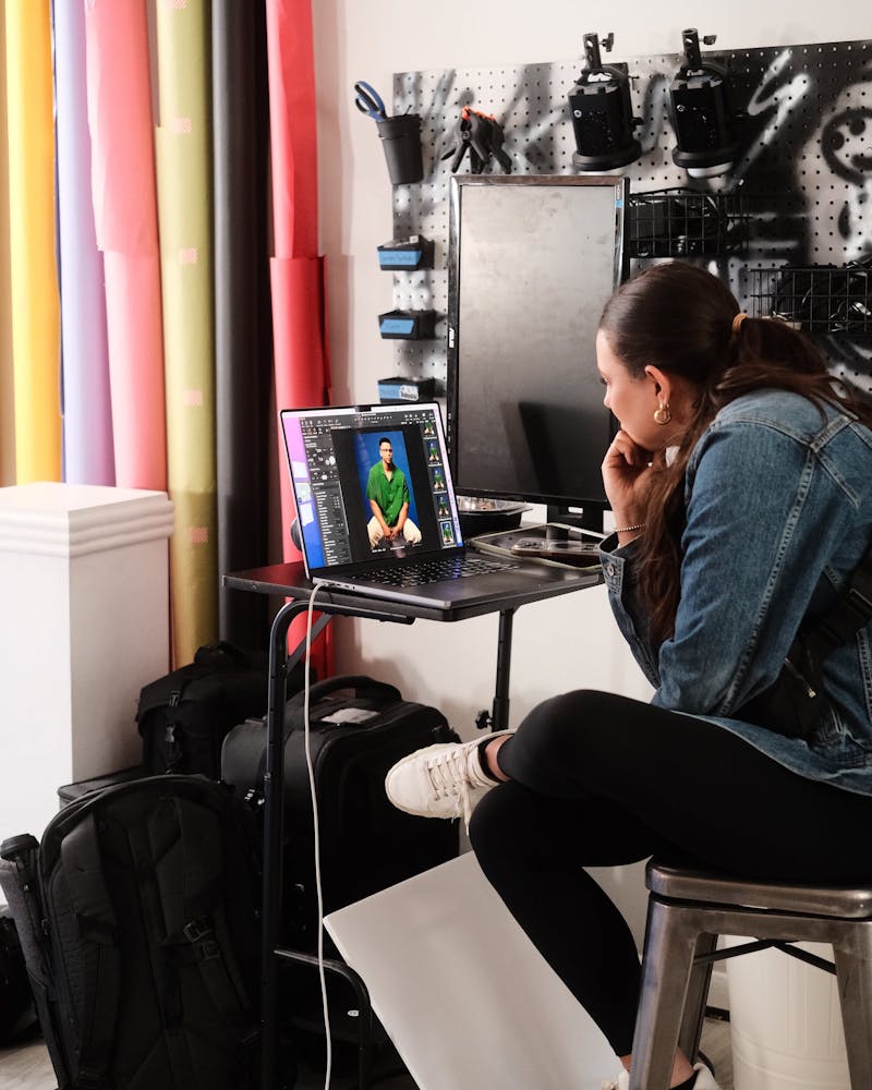 female director reviewing images at a photoshoot on a laptop