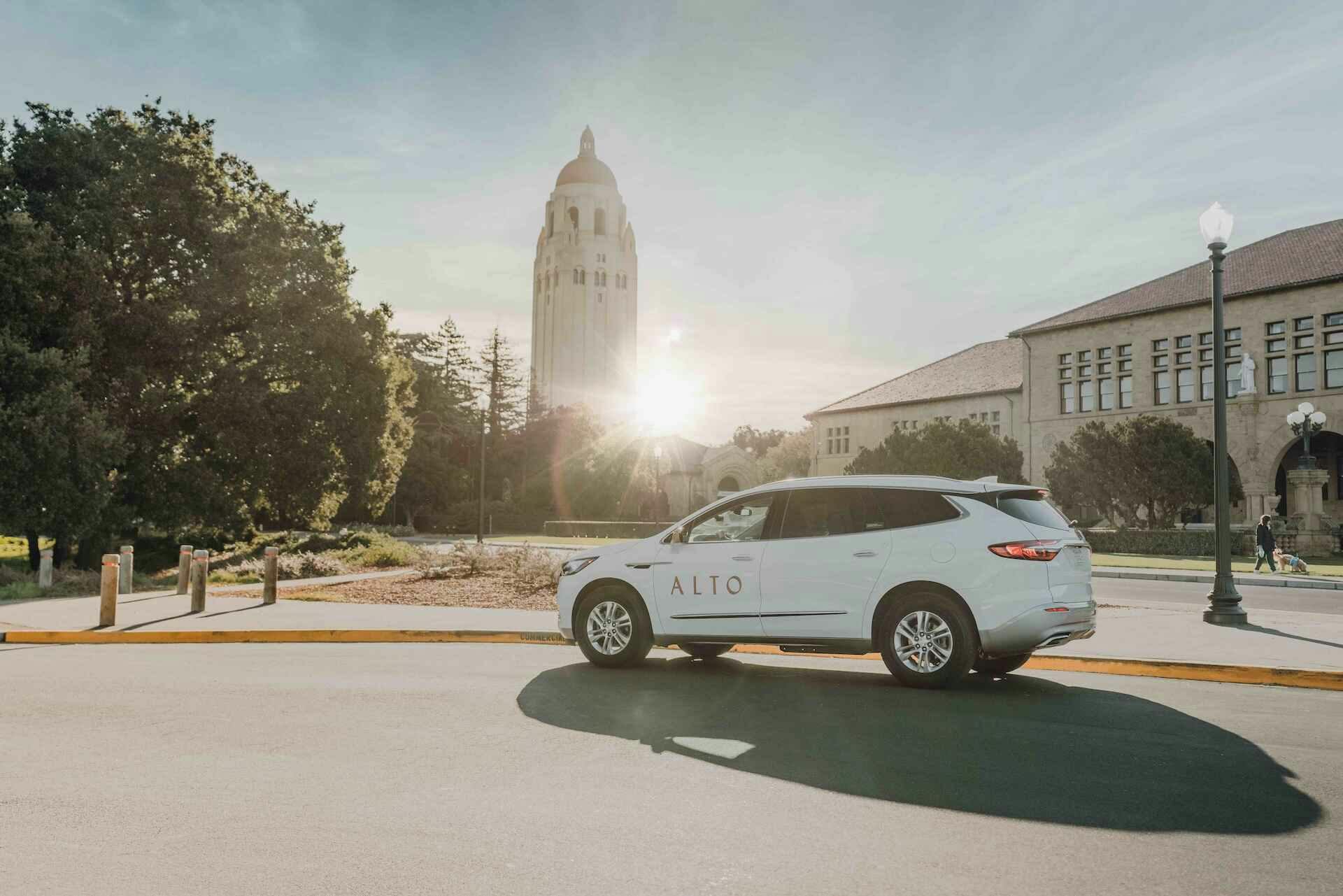 Alto ride share vehicle on a city street with a sunny background