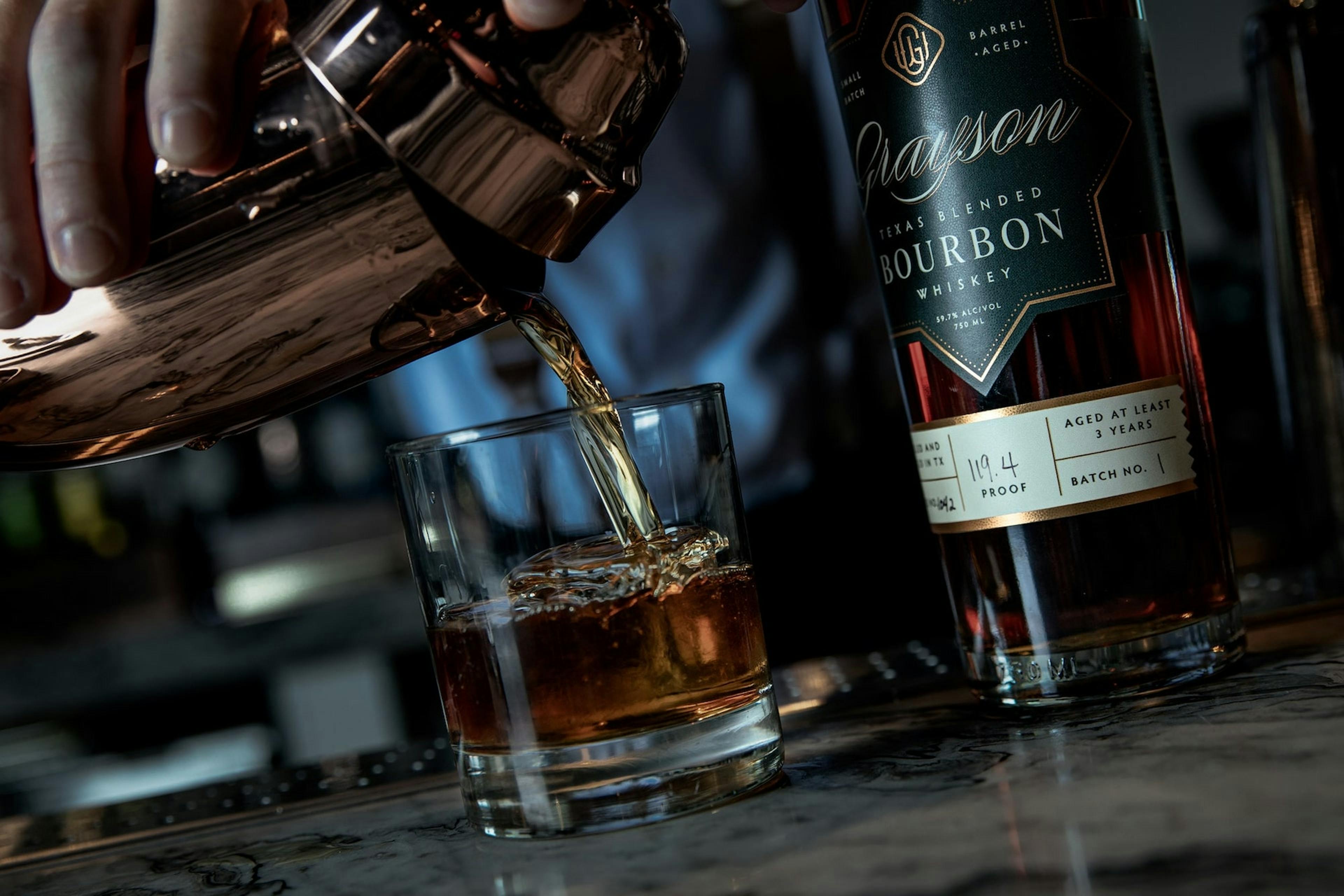 Grayson Bourbon being poured into a whiskey glass by a bartender