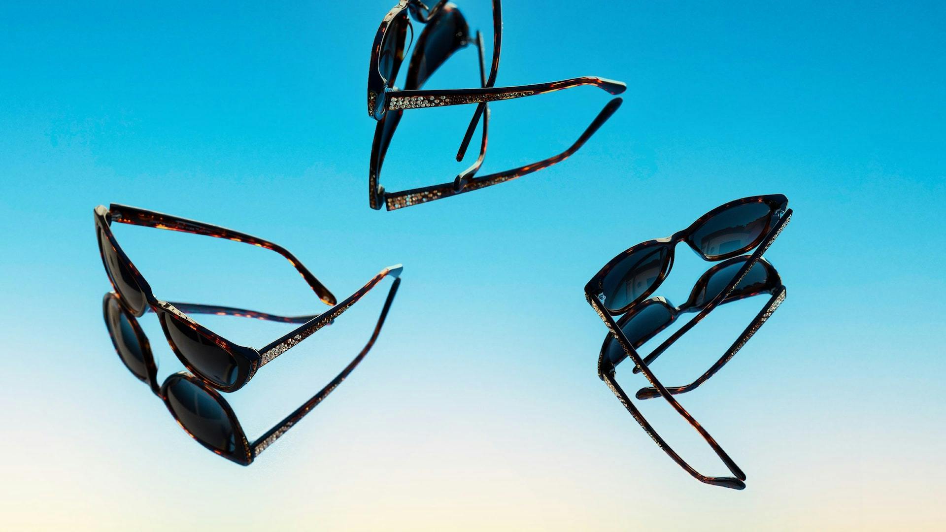 Product photos of Jimmy Crystal sunglasses on a mirrored background