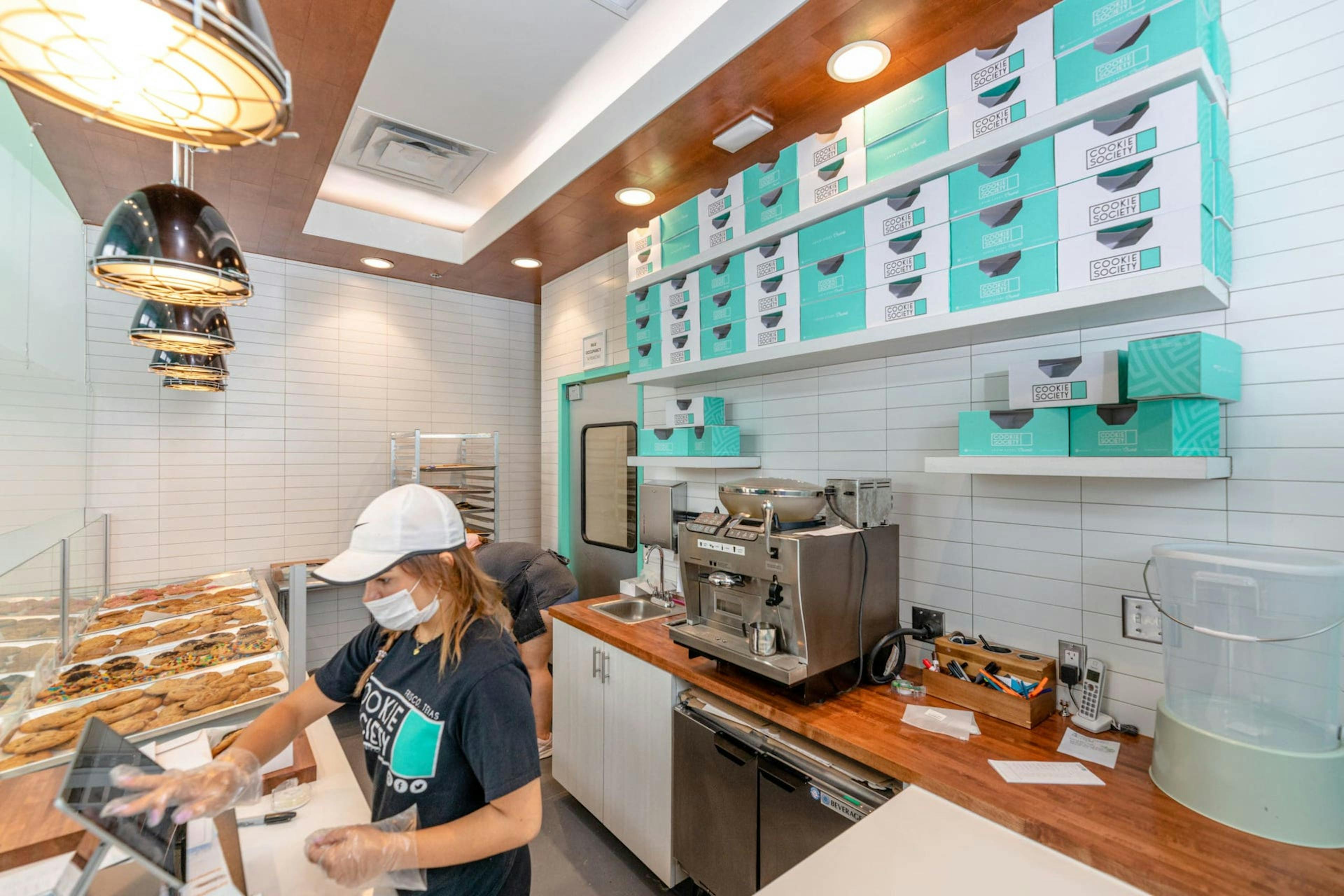 Cookie Society store employee working at checkout counter