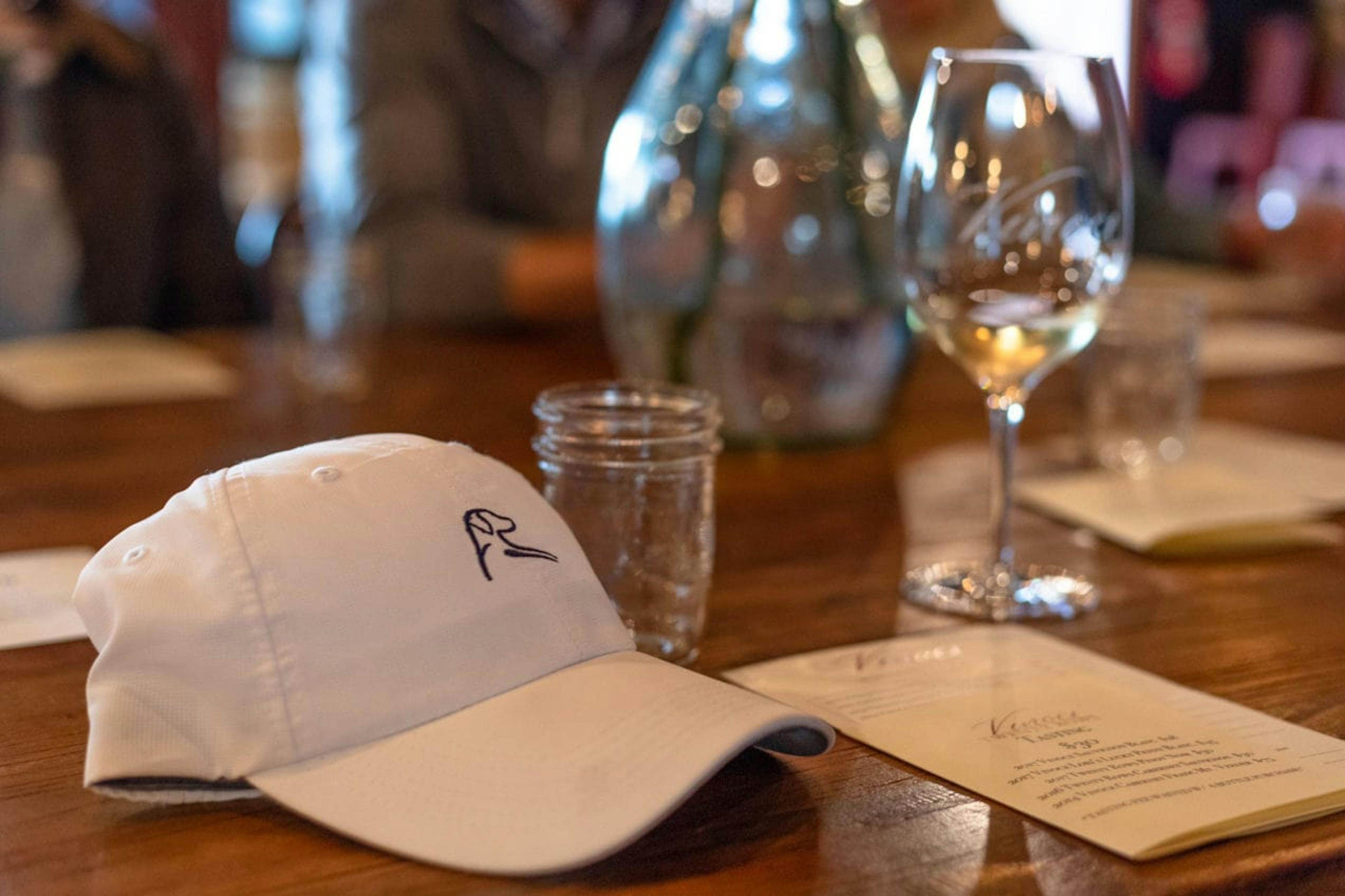 Rhoback hat and Two Old Dogs wine on a dinner table