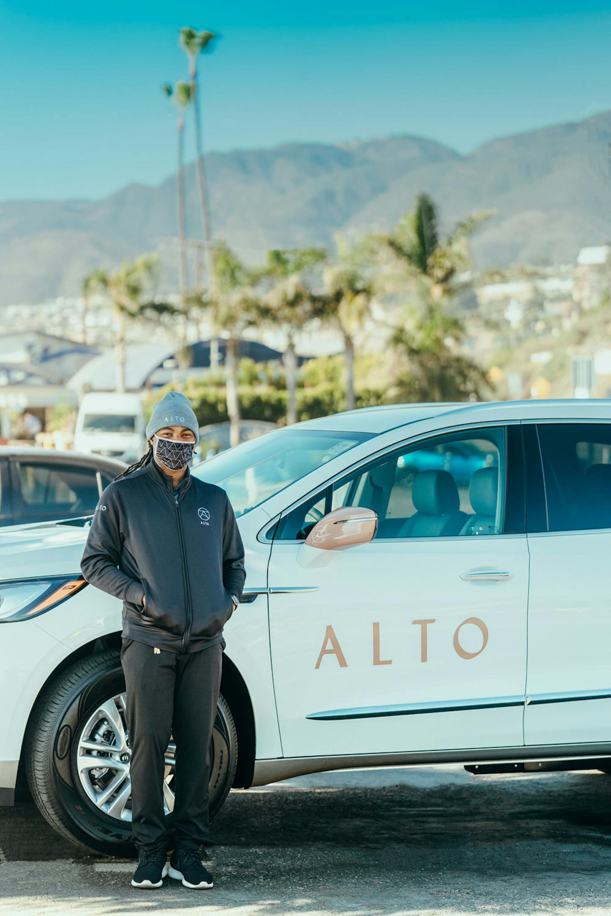 Alto Driver Standing Next to Vehicle