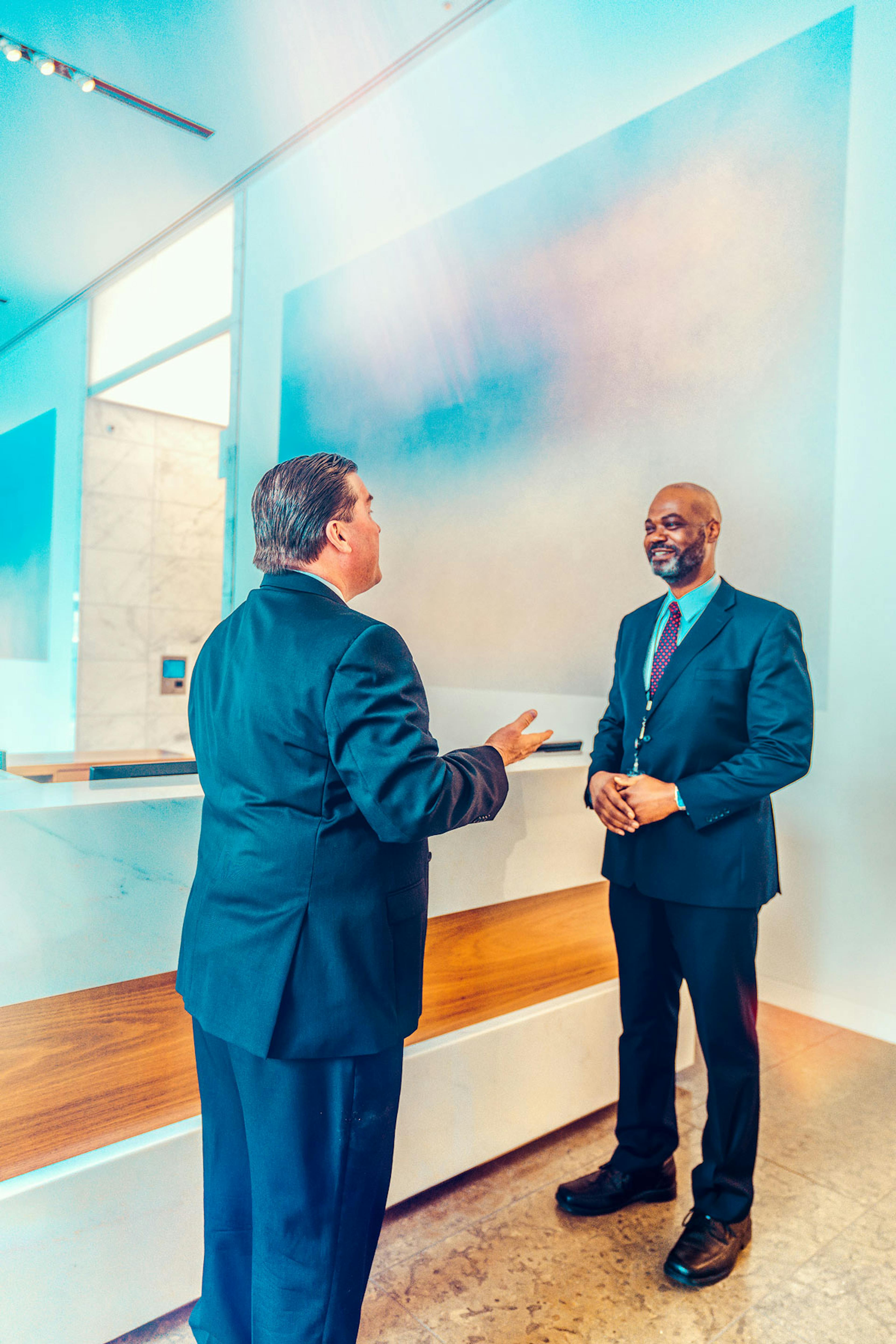 Two men talking In the lobby of Santander Tower In Dallas