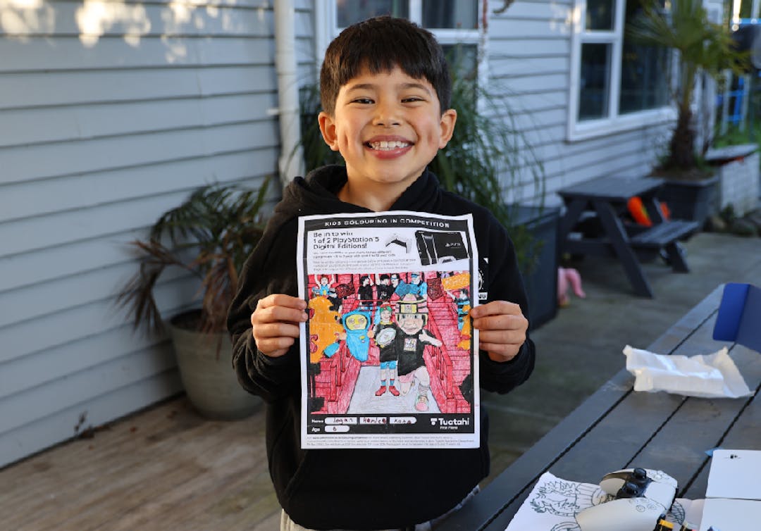 Photo of colouring in competition winner Logan aged 6 with his artwork