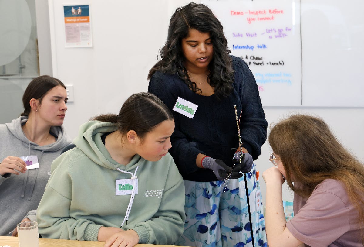 Lavinia Raj showing Te Kuiti High School students a fibre cable.