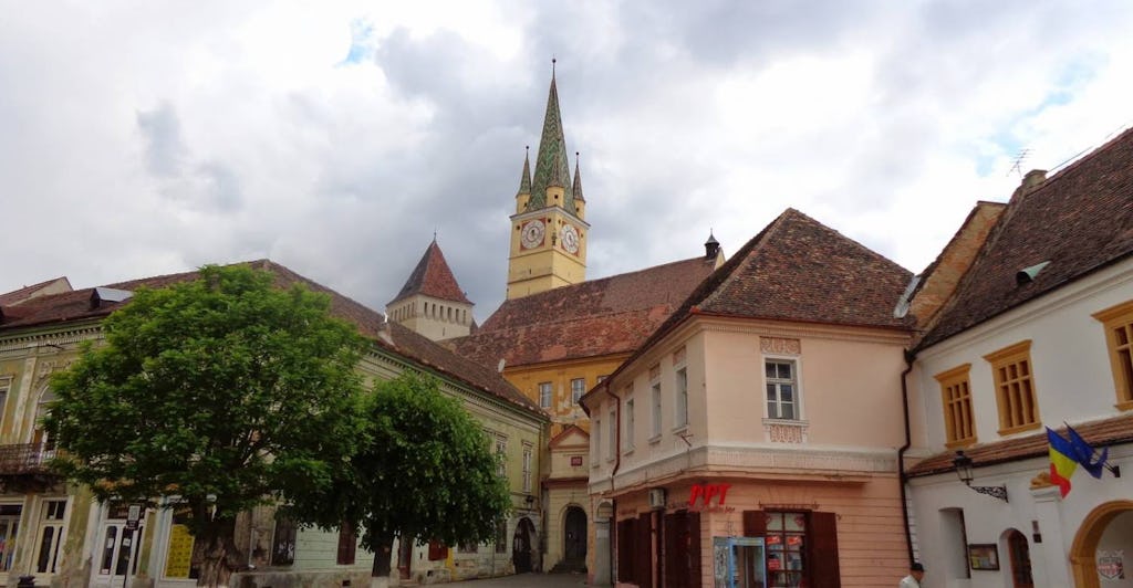 The city center of Medias with old houses and the tower