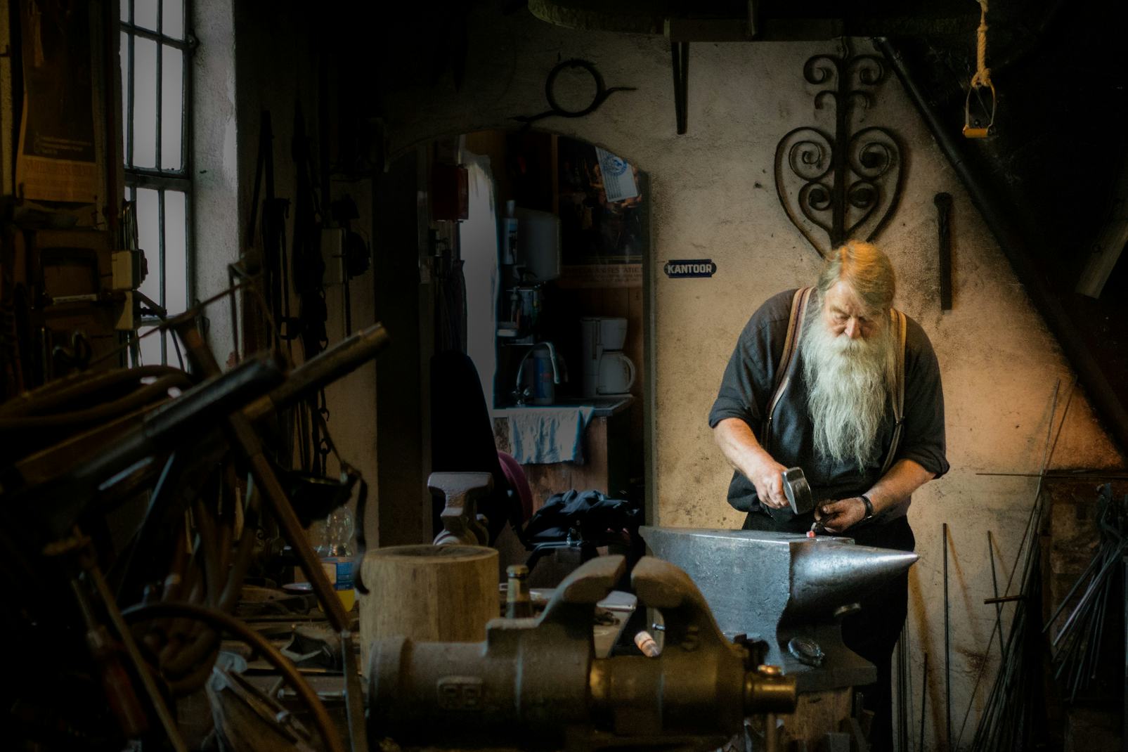Bărbat în vârstă lucrează în atelier medieval