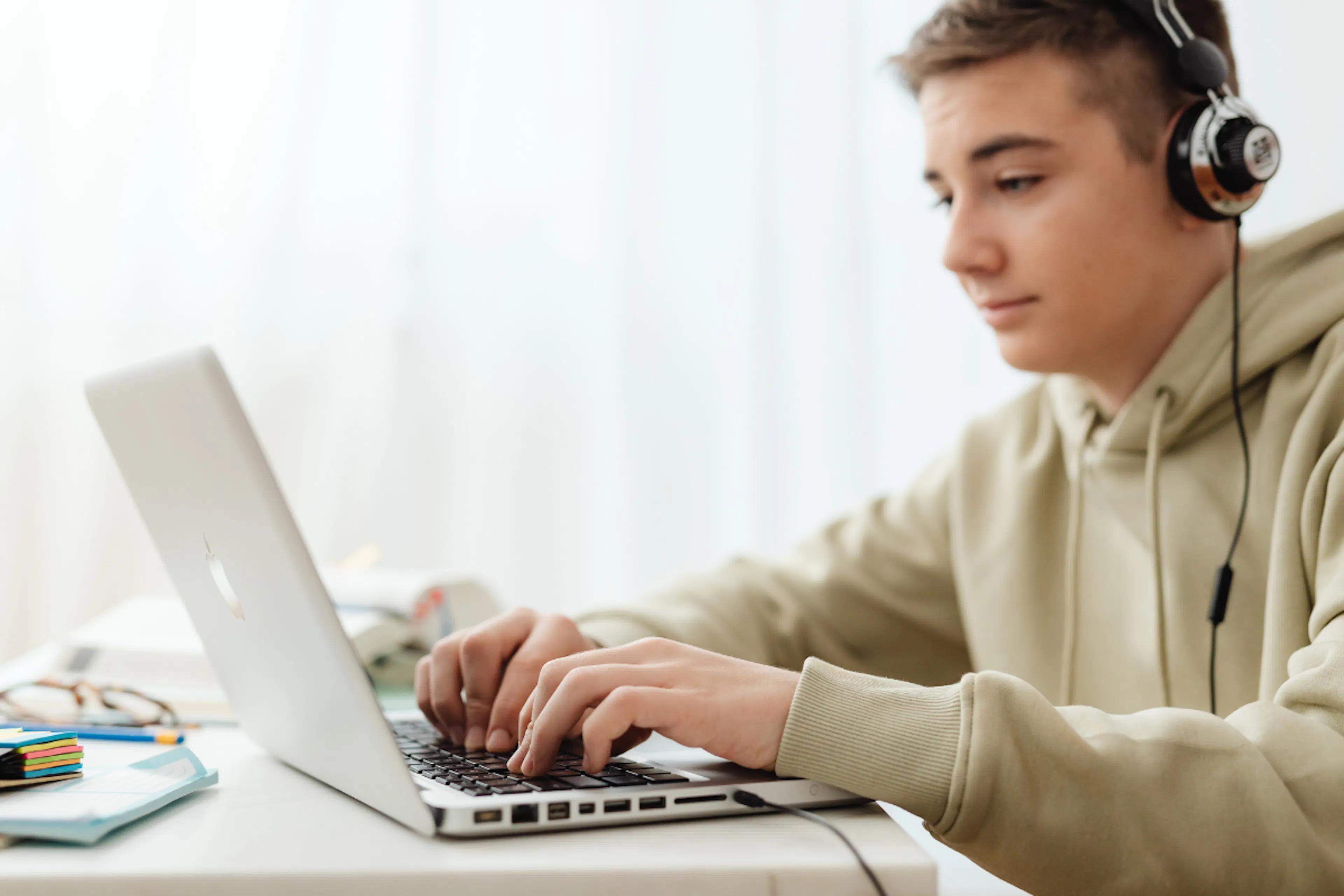 Boy in headphones tutoring on a laptop 