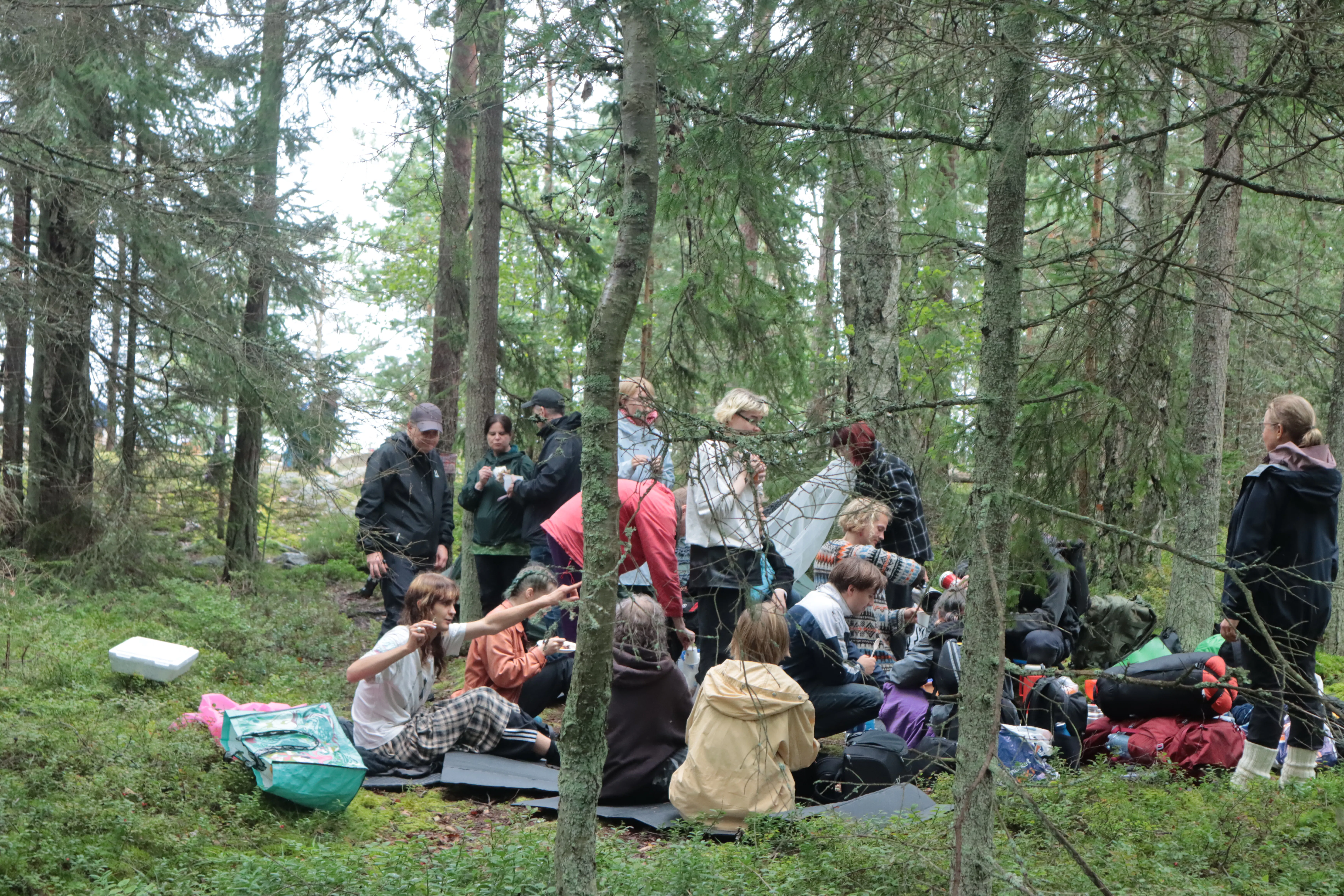participants eating soup in forest