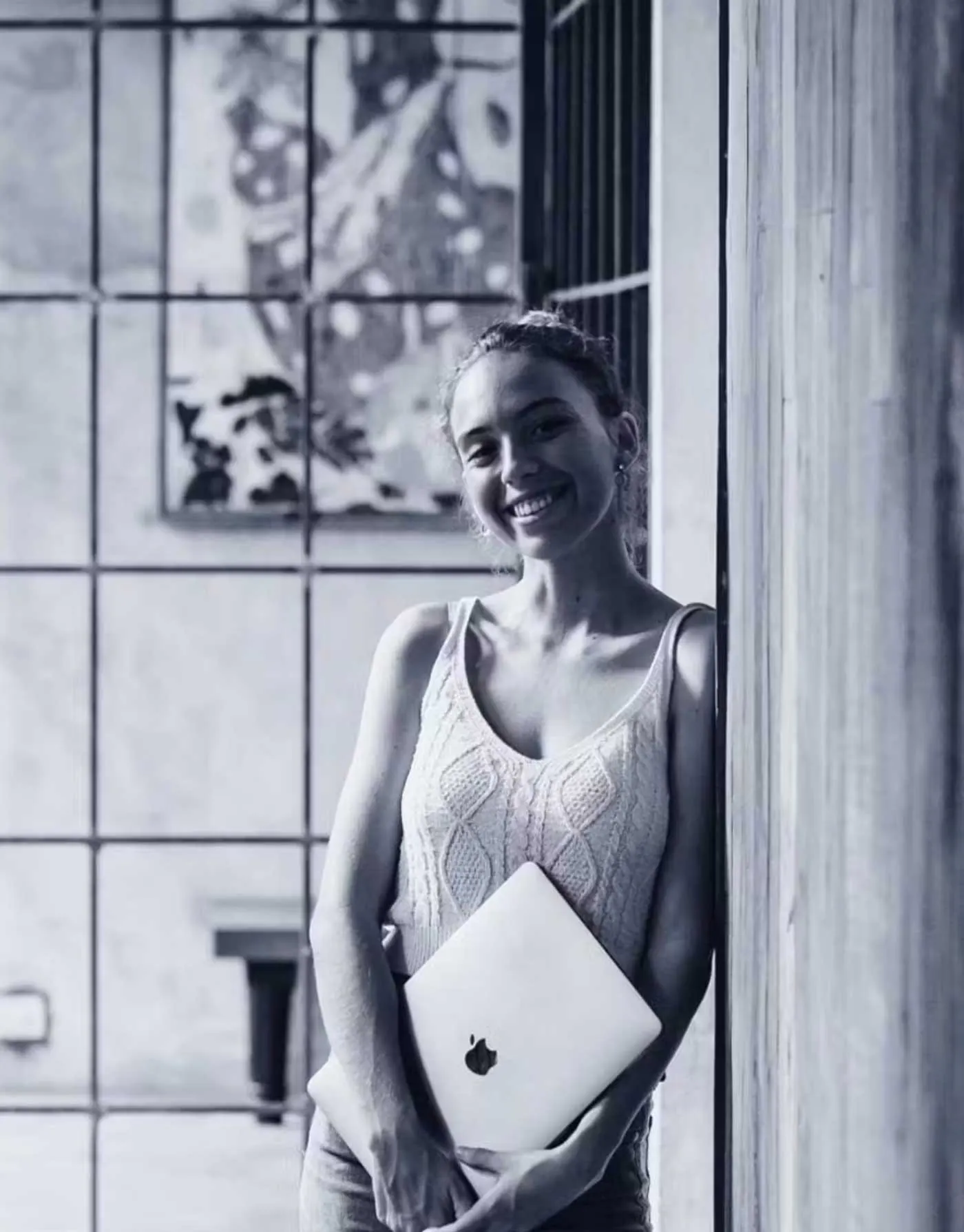 Lola, Co-founder of Two Moons Studio, holding her laptop