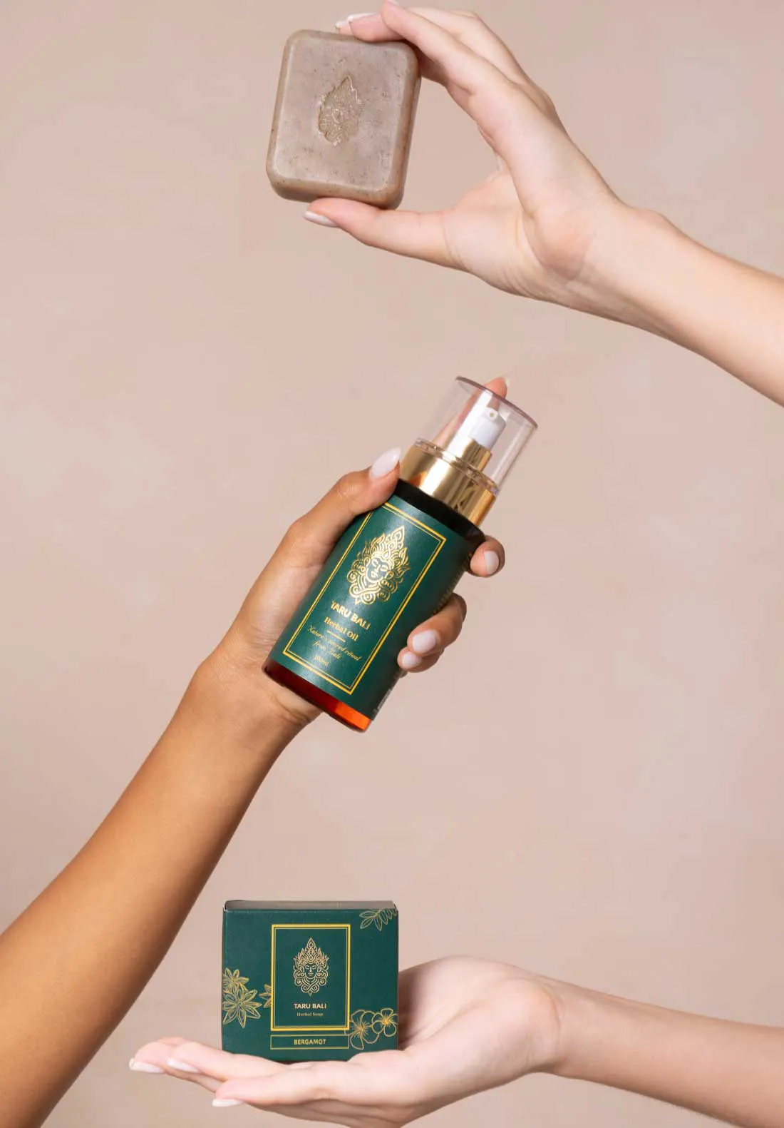 Herbal oil and herbal soap set against a beige background