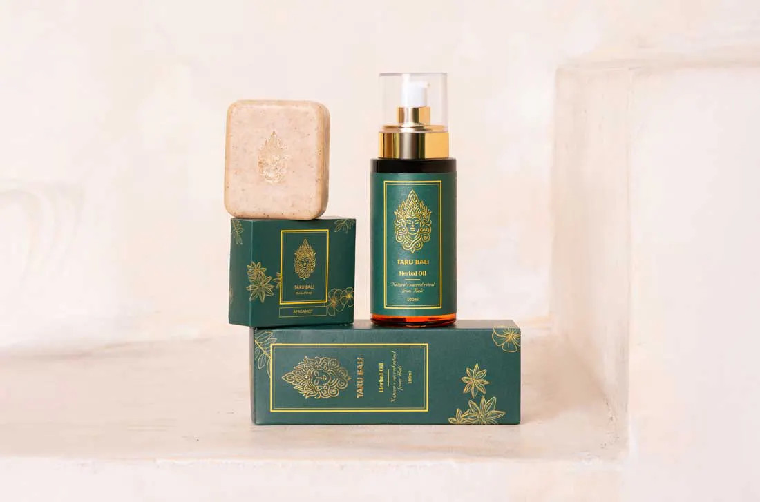 Herbal oil and herbal soap set against a beige background