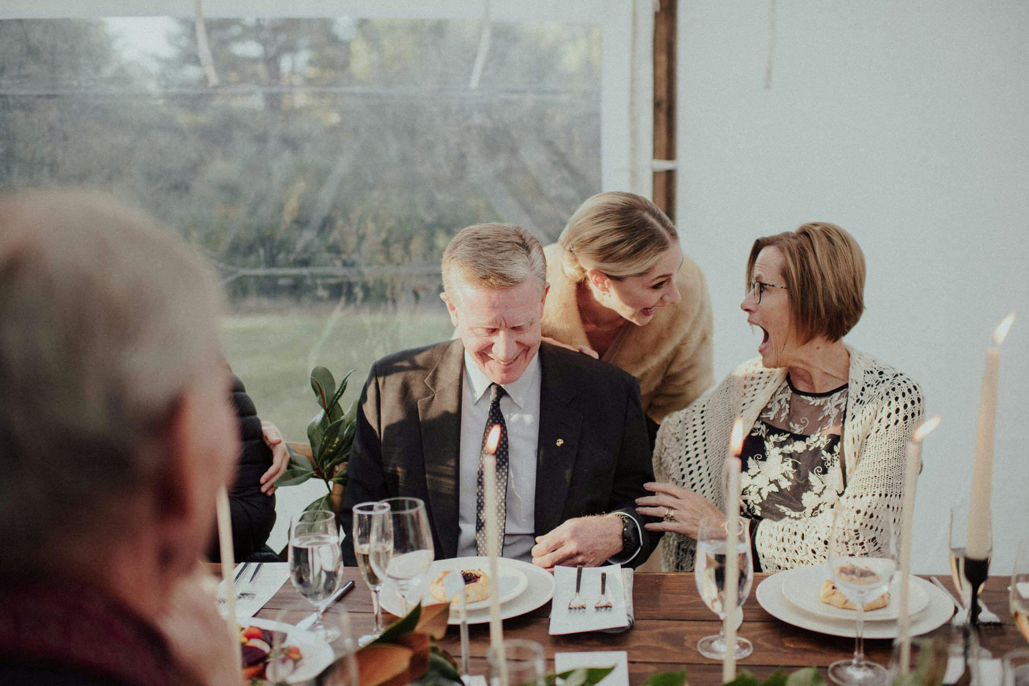 bride laughs with her parents
