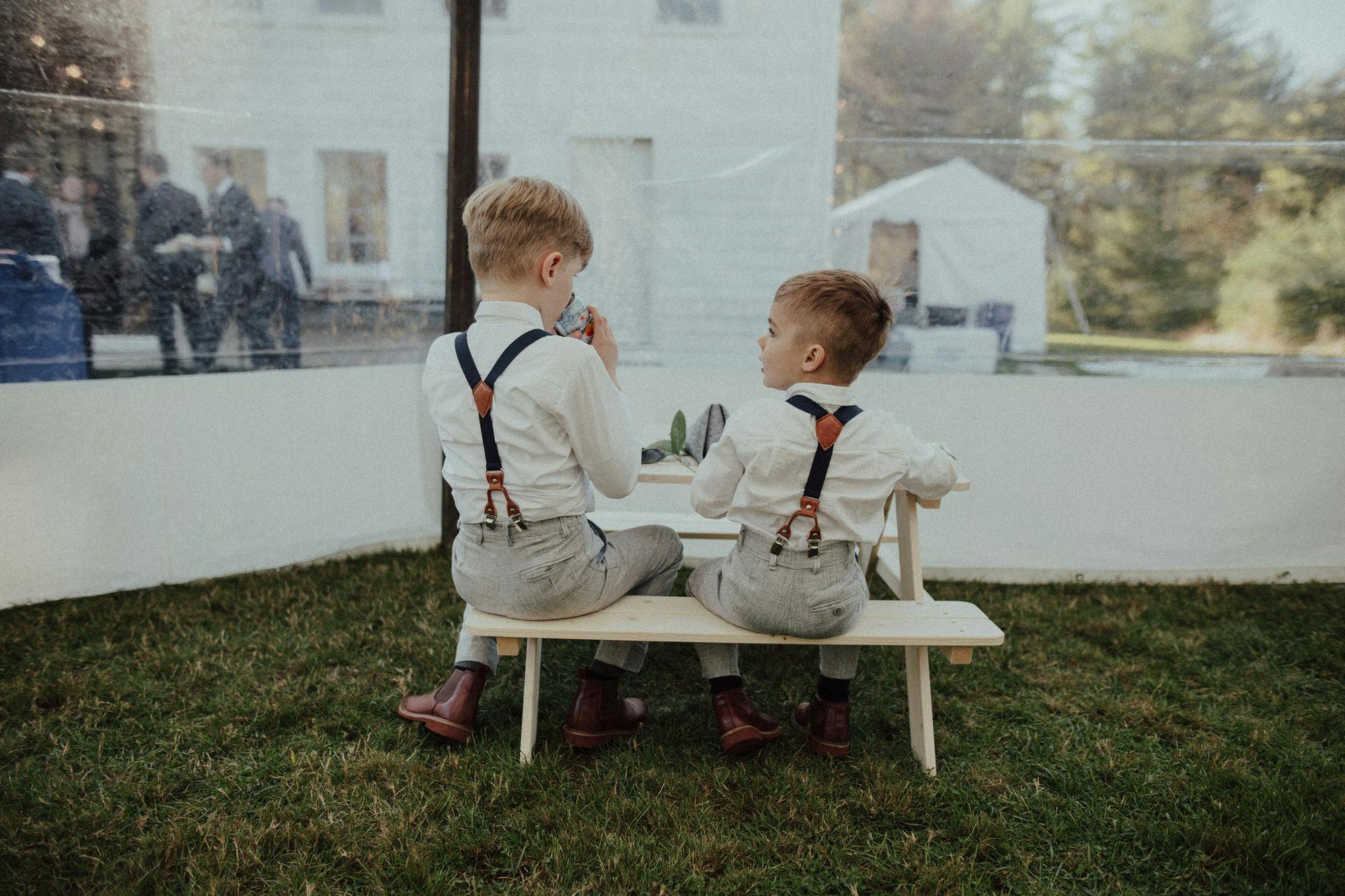 two ring bearers at their own table at a wedding