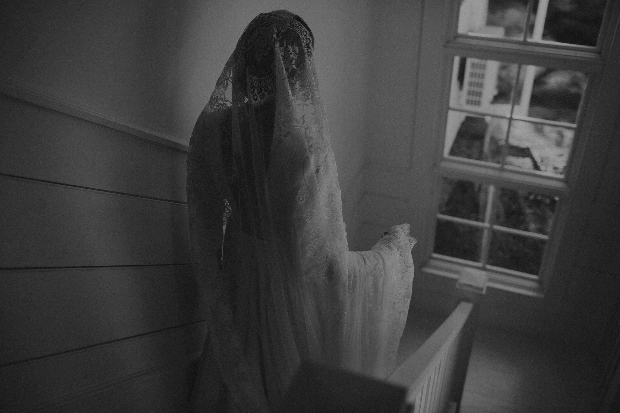bride walking down stairs in her custom made dress