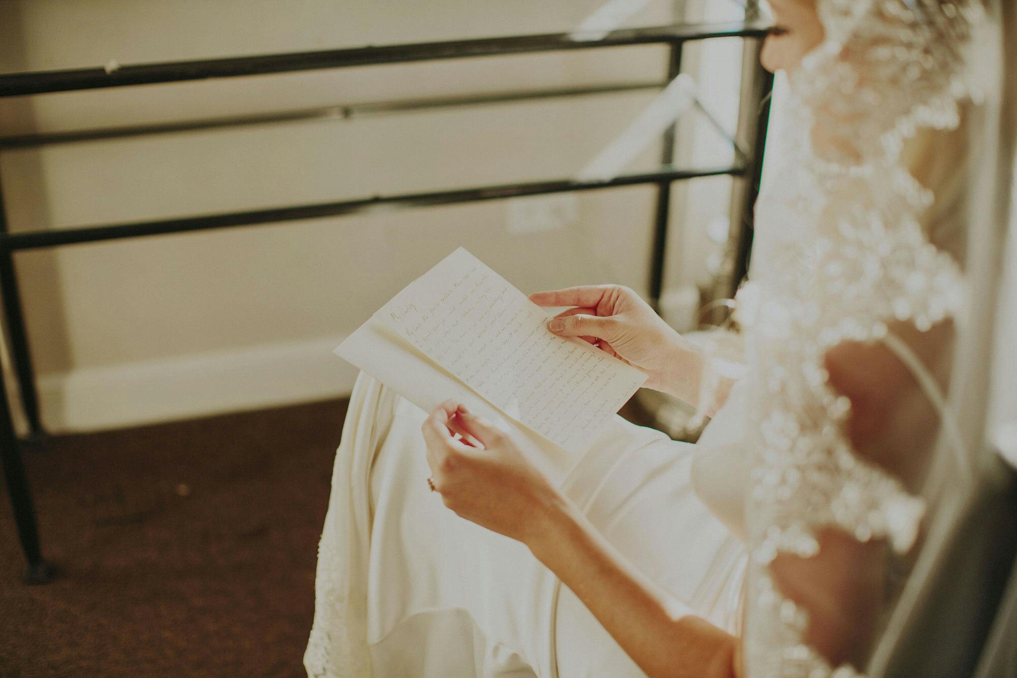 bride reading a note from her husband 