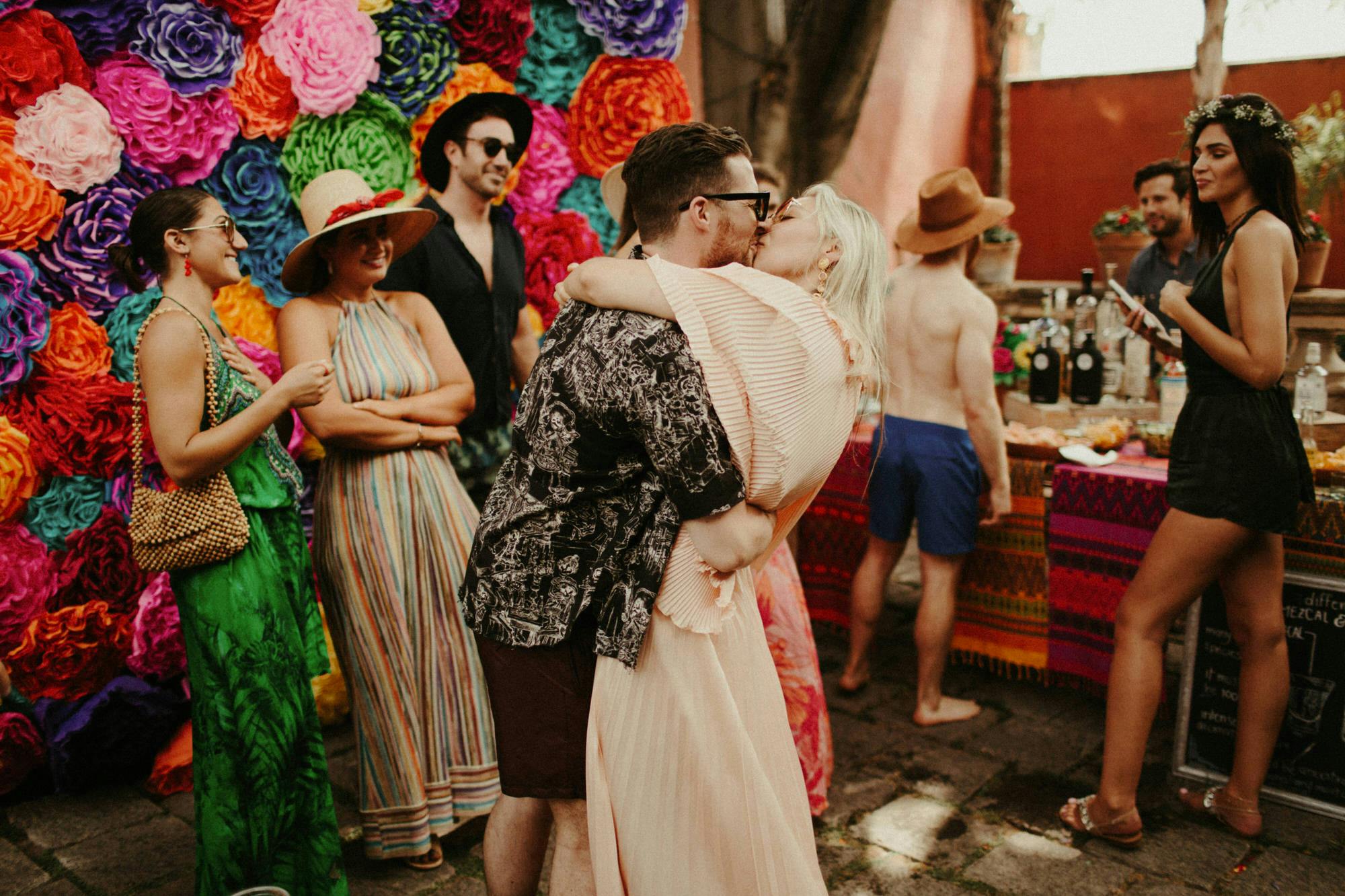 couple kissing at their pool party in san miguel