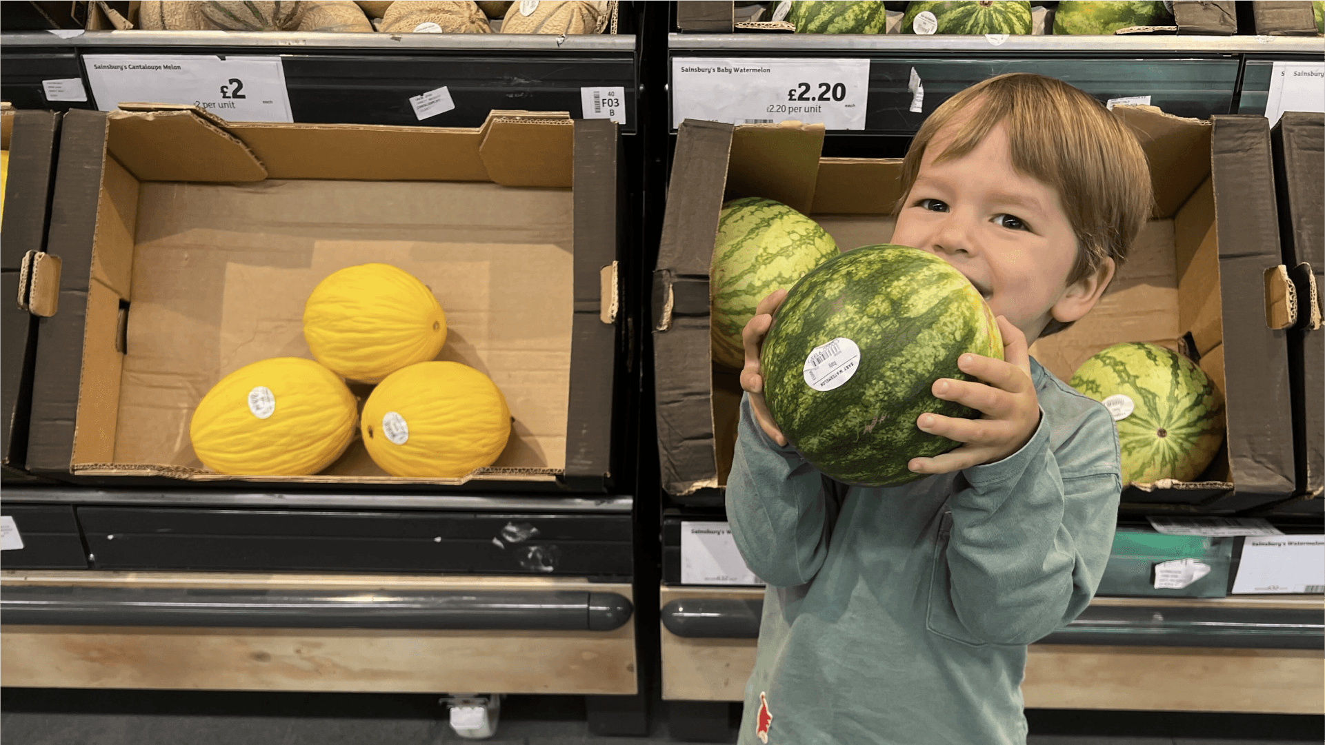 A child holding a watermelon playing supermarket dash!