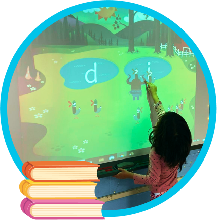 A child playing Teach Your Monster to Read on an interactive whiteboard