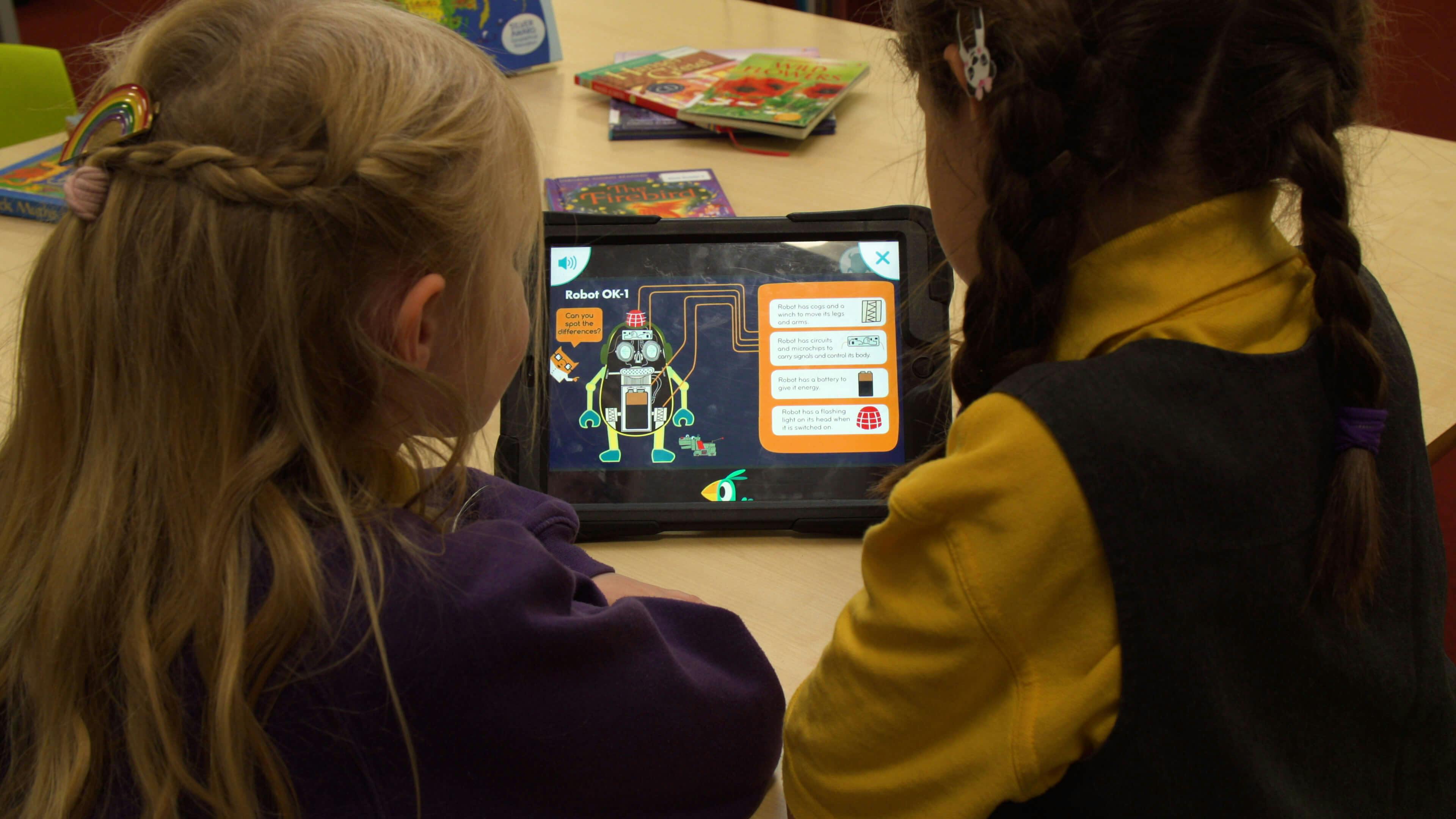 Two children using reading for fun