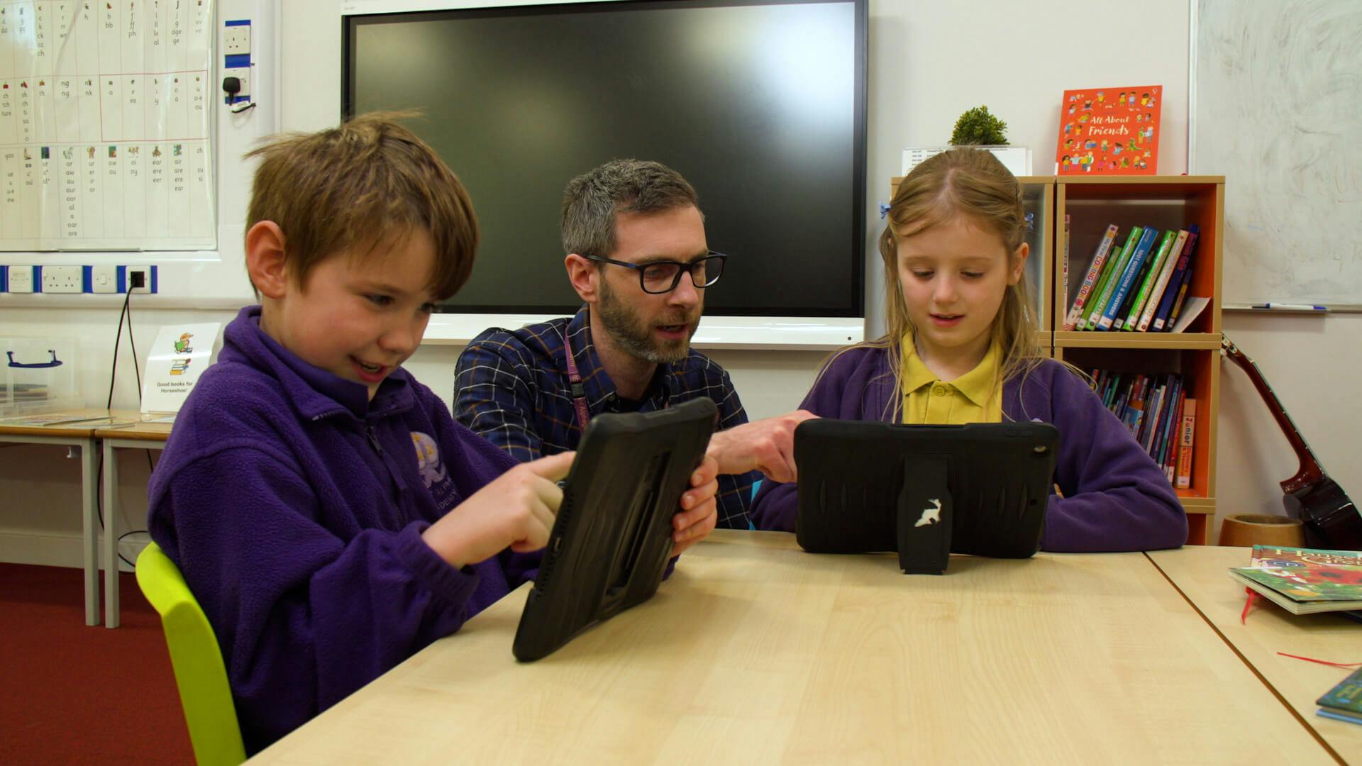 Teacher using Reading for Fun with two students