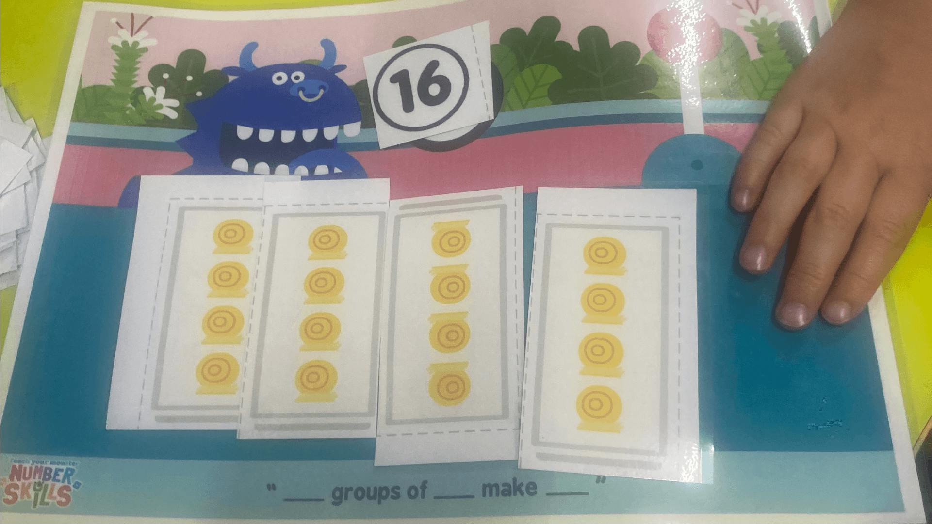 A child making 4 groups of 4 to make 16 on our Dino Dash game