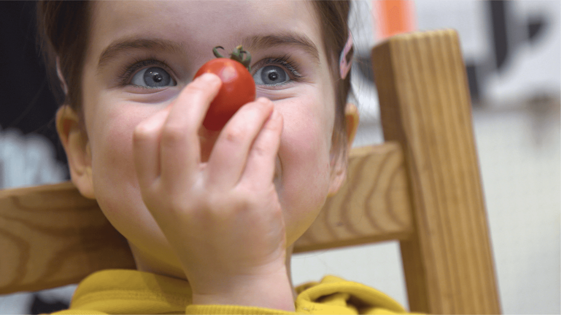 The power of fruit and vegetables! A child holding a tomato