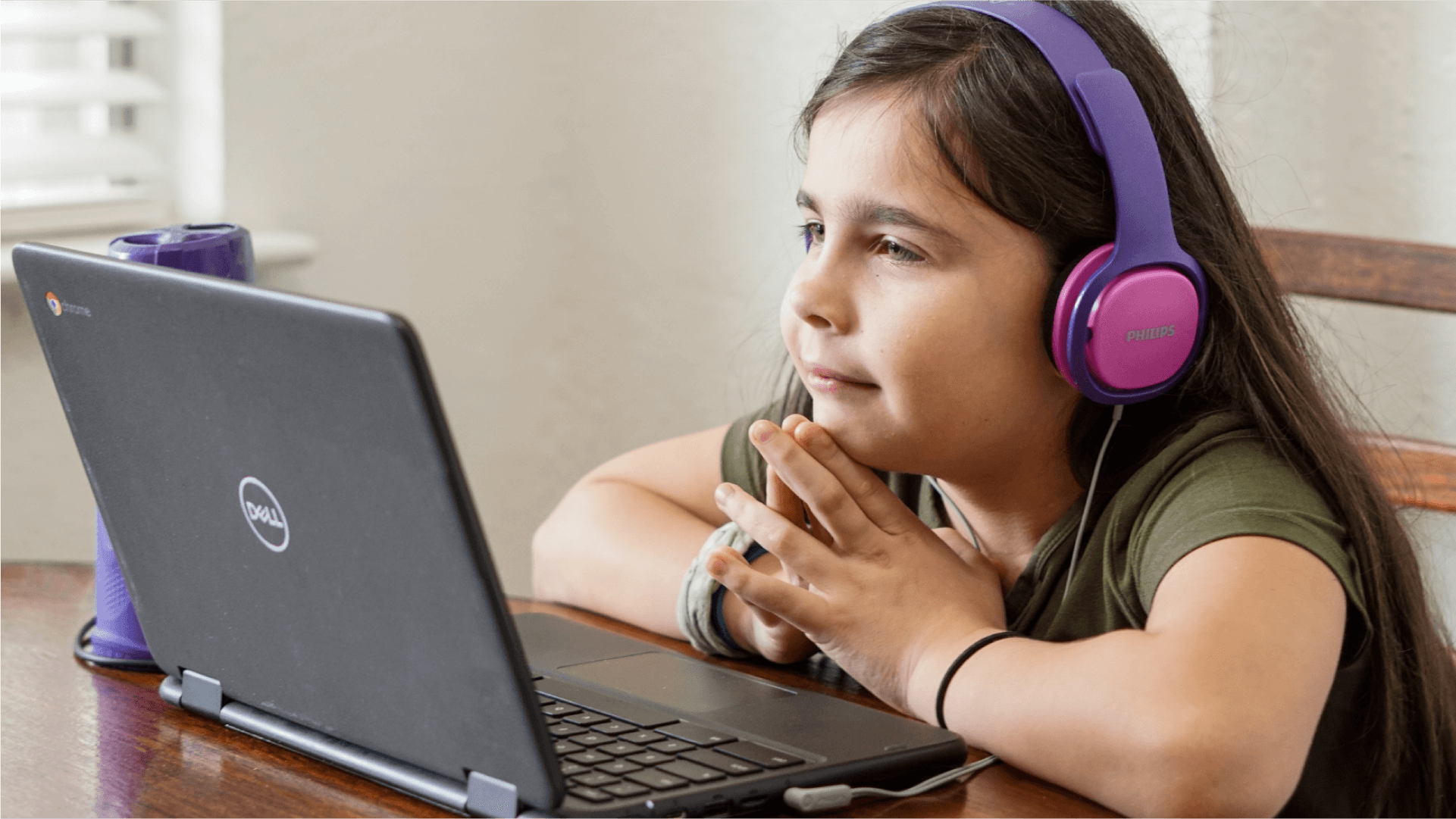 Girl playing Teach Your Monster to Read on a laptop