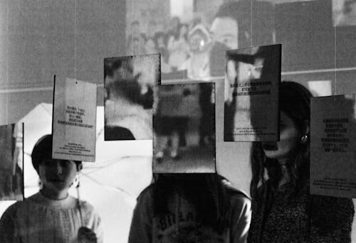 3 people viewing wooden boards with projected images atop them