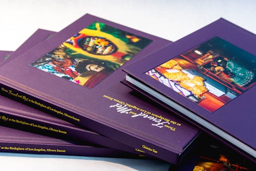 Five purple books piled up.