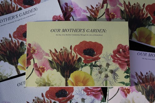 A light green book with colorful flowers called Our Mother's Garden.