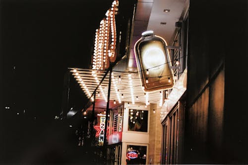 a photograph of a building with bright lights, at night