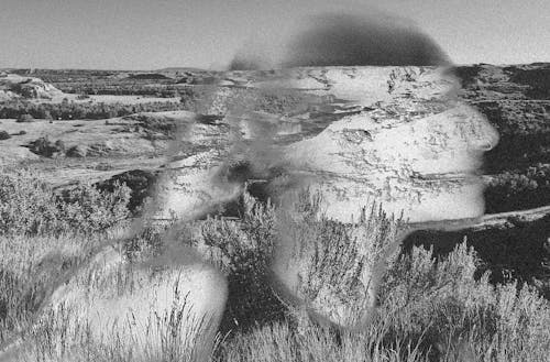 Composite picture of a spectral indigenous woman traversing a prairie.