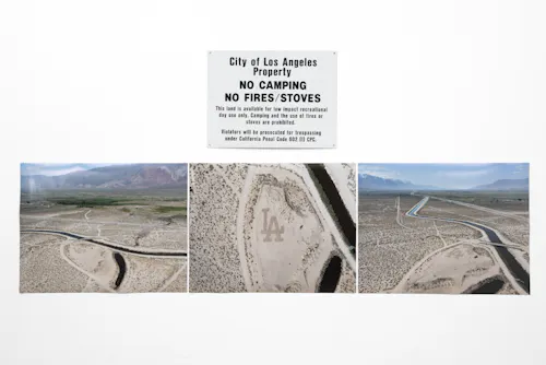 Arial photo of the Los Angeles Dodgers logo drawn in a dirt patch next to the Los Angeles Aqueduct