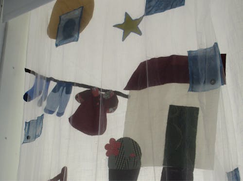 Close up shot of a textile collage curtain. 