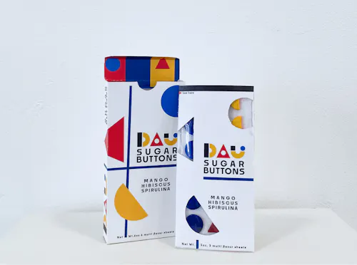 Bauhaus style multiples and singles candy button package design sit in front of a white backdrop.