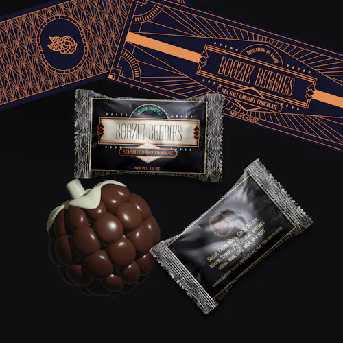 A 3D-rendered model of colorful, glossy chocolate pieces is displayed in the foreground, shaped like small rounded berries with a subtle sheen, suggesting a chewy texture. Behind the candy sits the product’s packaging, which is sleek and modern with a bold navy blue base and peach accents. The front of the package includes art-deco, sans-serif text and a small graphic logo, while the back reveals a net weight and flavor, partially visible. The composition is clean and evenly lit, with the items placed on a neutral surface that emphasizes the vibrancy of the candy and packaging.