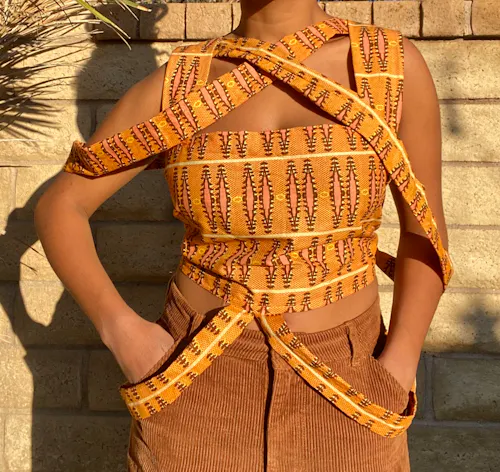 This work is a sewed top with African fabric with ribcage like features. Made by Makeda.