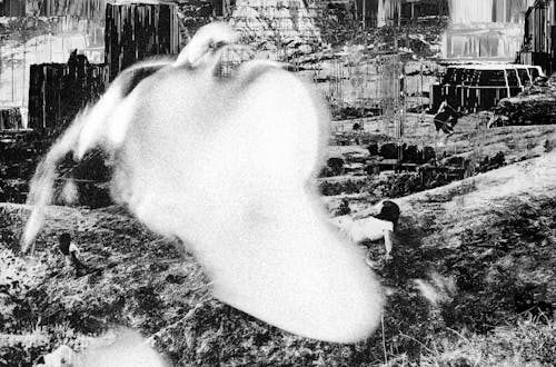 Composite picture of a spectral indigenous woman sprawled across a distopic landscape.